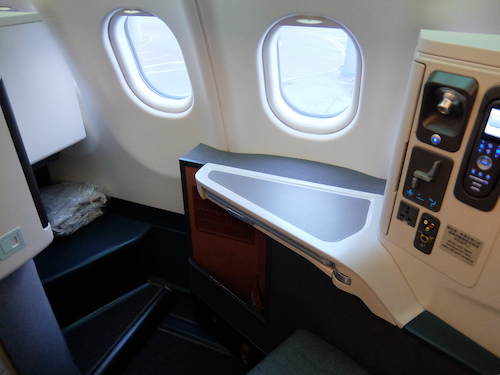 A convenient fixed side table is accompanied by a fold out dining table.