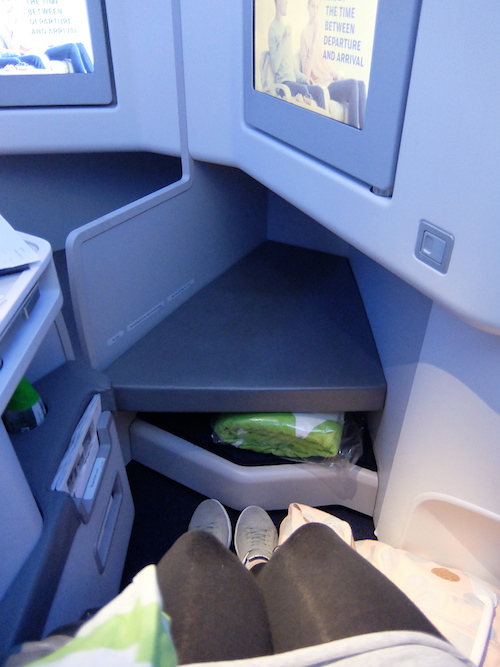 Storage under the footrest, in this photo contains the quilt.