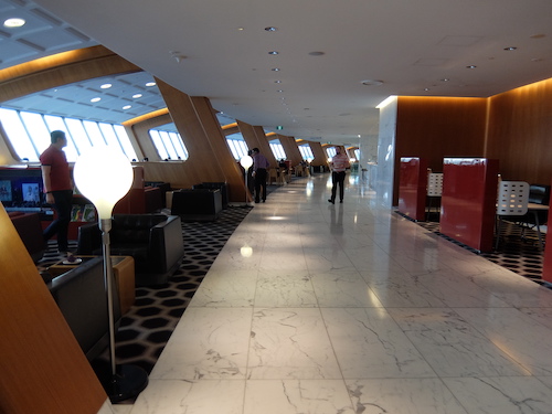 The lounge is divided into different zones by striking wooden frames.