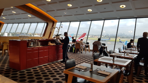 The lounge is divided into different zones by striking wooden frames.