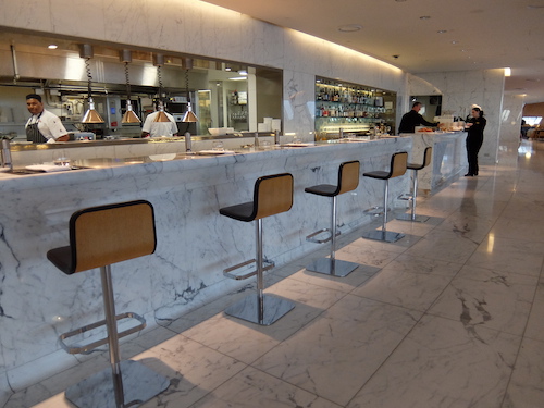 The signature bar with views into the Qantas First Class Lounge Kitchen