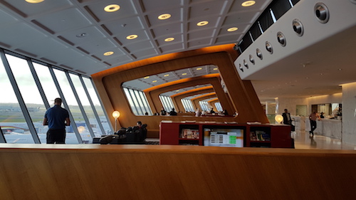 The lounge is divided into different zones by striking wooden frames.