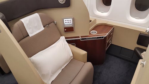 The seat in first class swivels to face the ottoman.