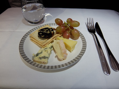 A selection of cheese and fruit.