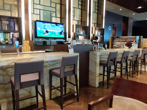 Fully stocked First Class bar, staffed with a bartender.