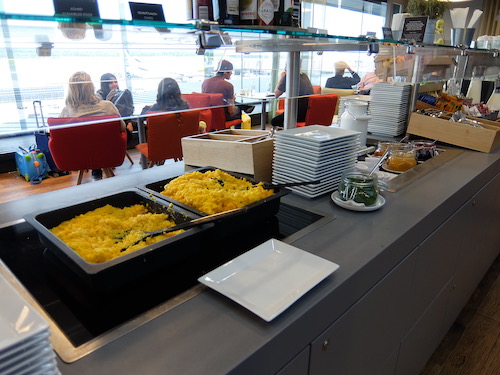 Breakfast food including scrambled eggs served in the Austrian Airlines lounge buffet.