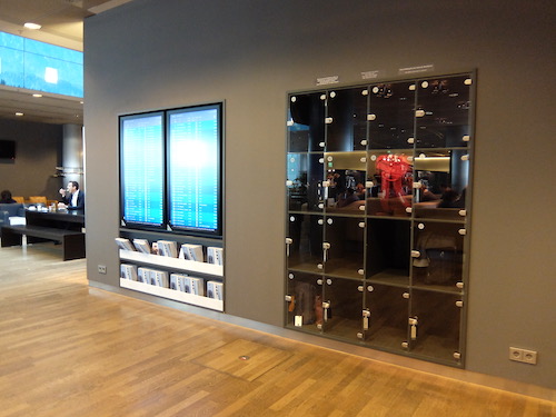 Lockers and departures information inside the Lufthansa Lounge.