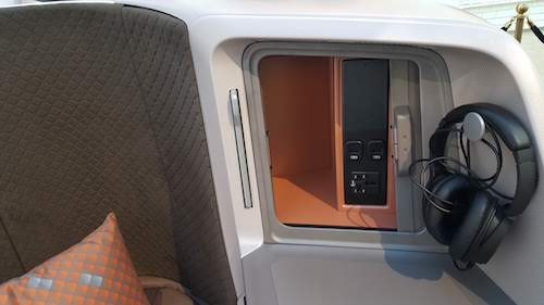 Singapore Airlines Storage compartment and headphone hook.