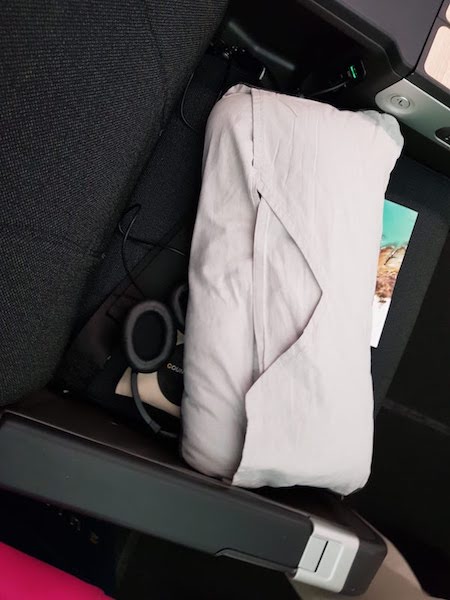 The Qantas Premium Economy pillow case, designed to attach to your headrest